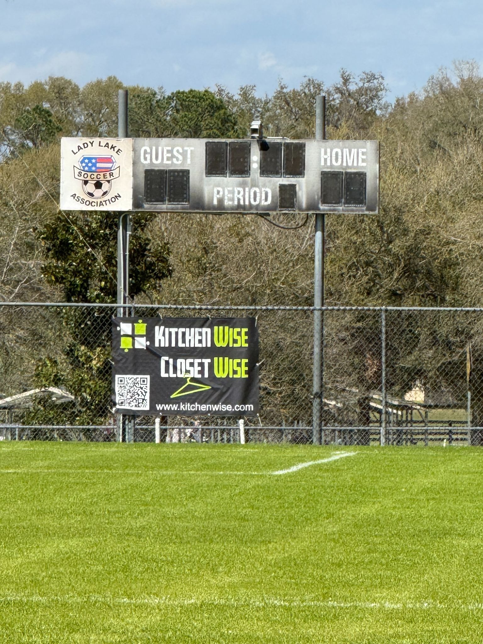 a sign on the football field fence line